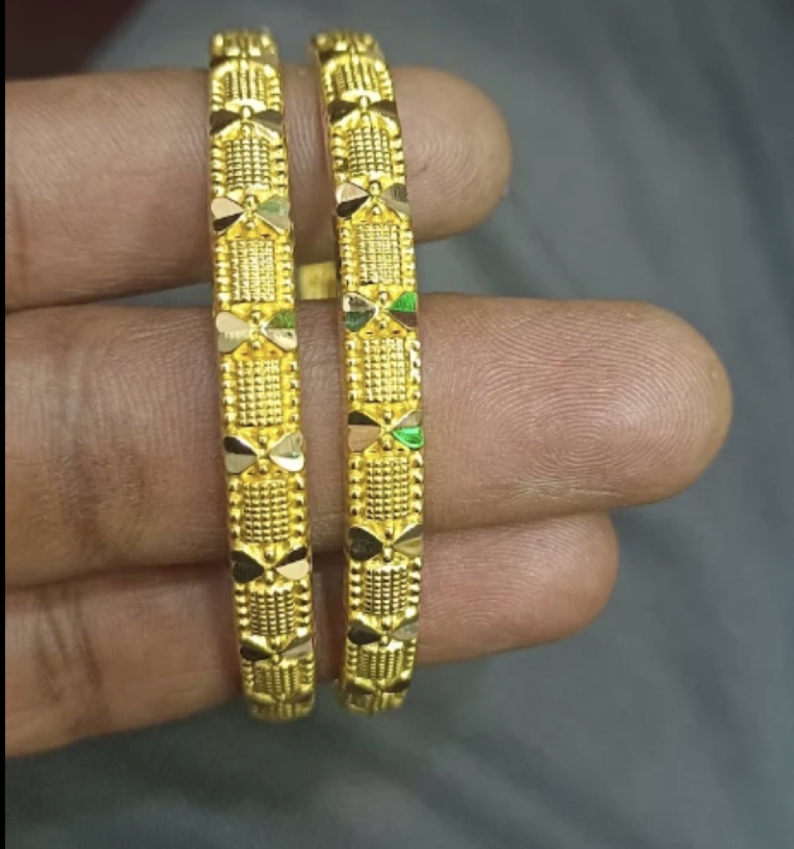 Pair of machine-cut gold bangles