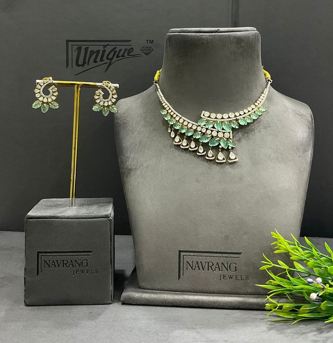 Diamond necklace with green stone leaves and matching earrings