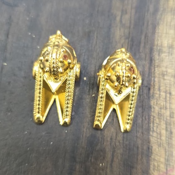 Gold earrings in the making on the workbench
