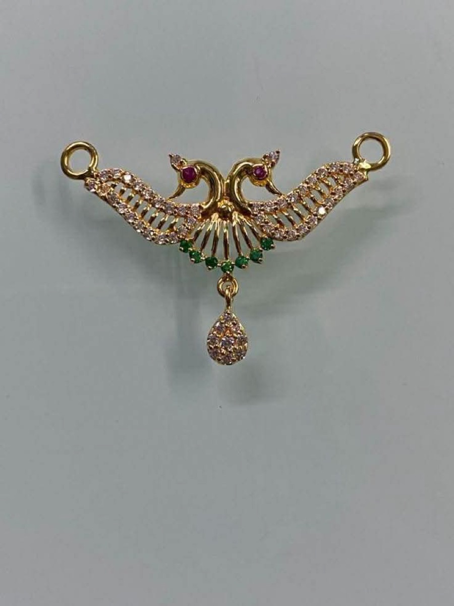 Gold peacock pendant with stones
