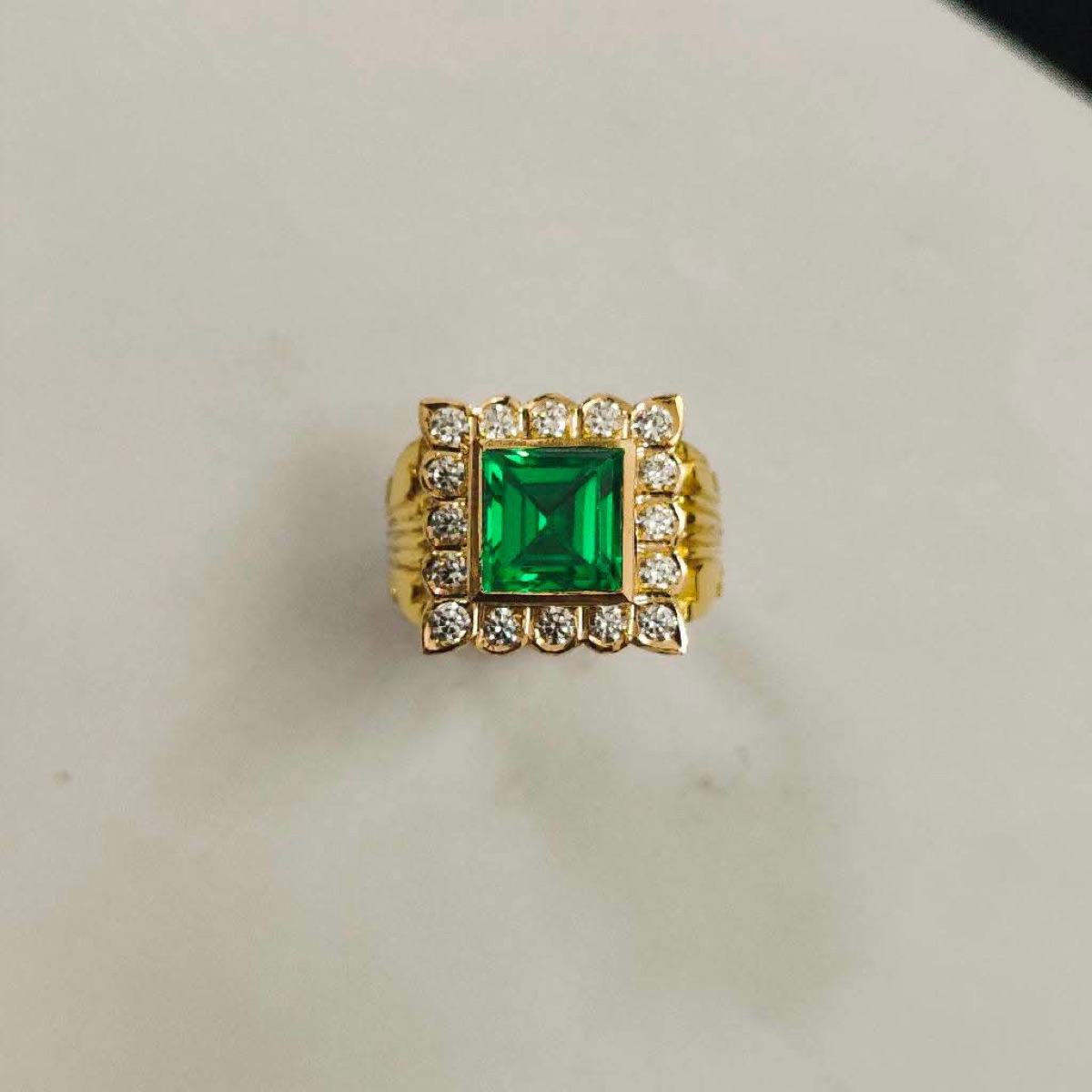 Gold ring with green stone and white stones