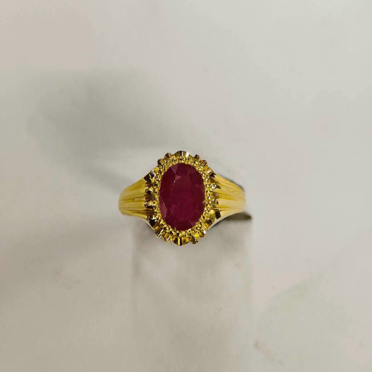 Gold ring with a red stone