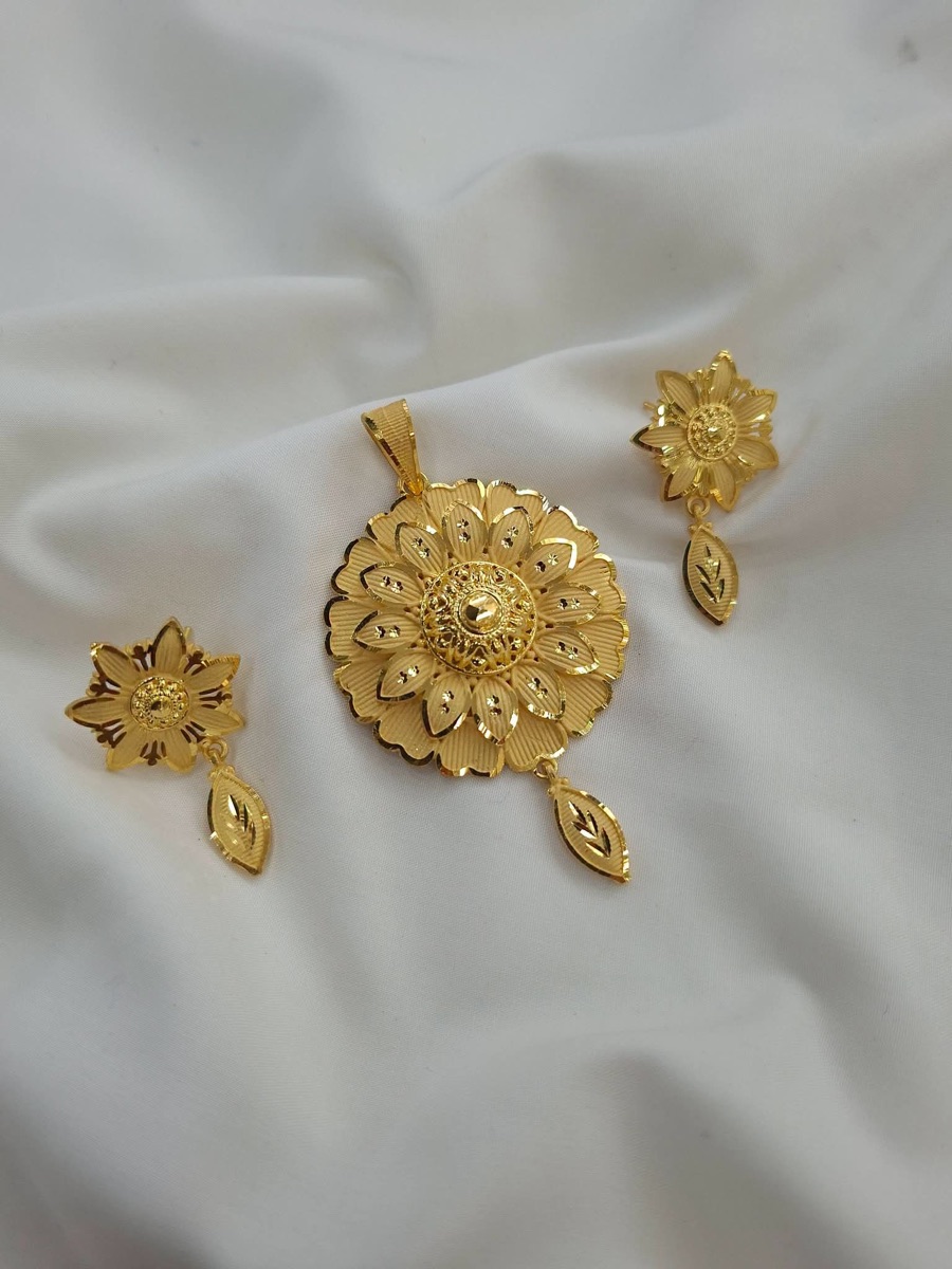 Gold flower pendant with matching earrings